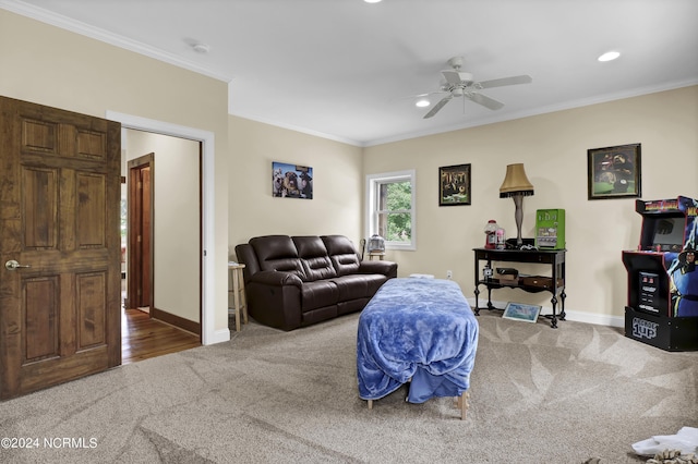 carpeted living area with recessed lighting, crown molding, baseboards, and ceiling fan