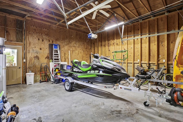 garage featuring wooden walls and a garage door opener