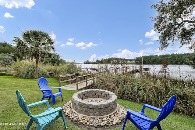 view of yard featuring a boat dock and an outdoor fire pit