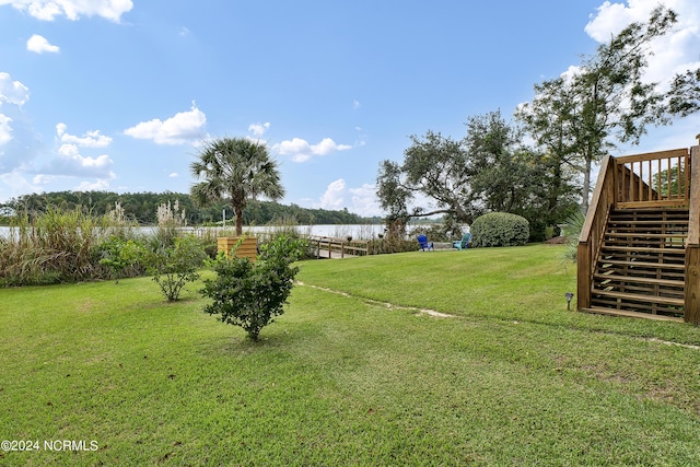 view of yard with a water view and stairs