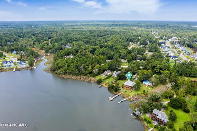 drone / aerial view with a forest view and a water view