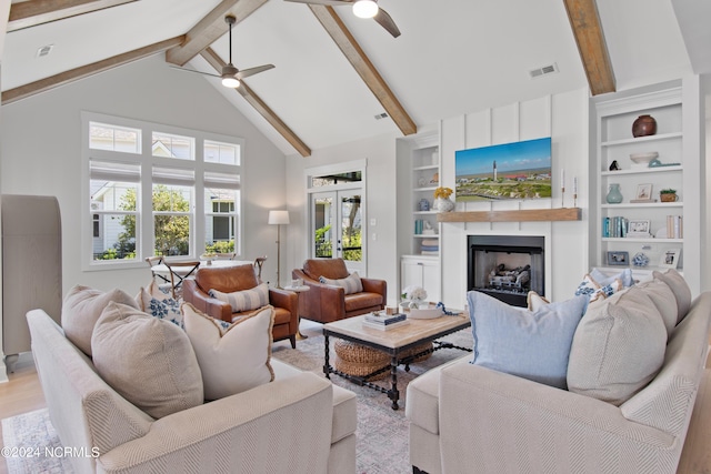 living room with a fireplace, high vaulted ceiling, light hardwood / wood-style floors, beamed ceiling, and ceiling fan