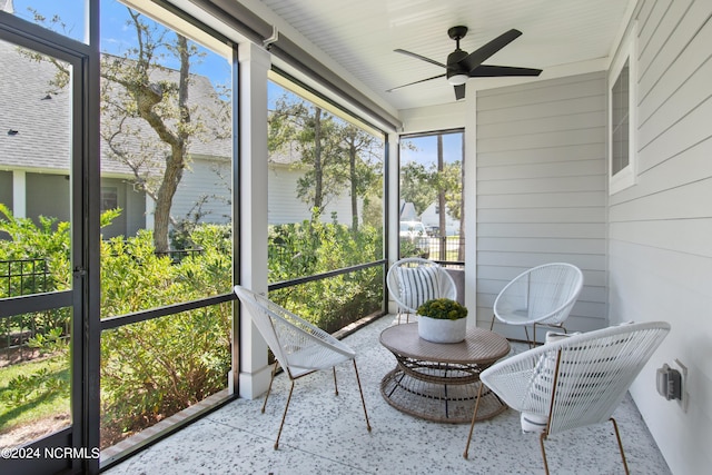 sunroom / solarium featuring ceiling fan