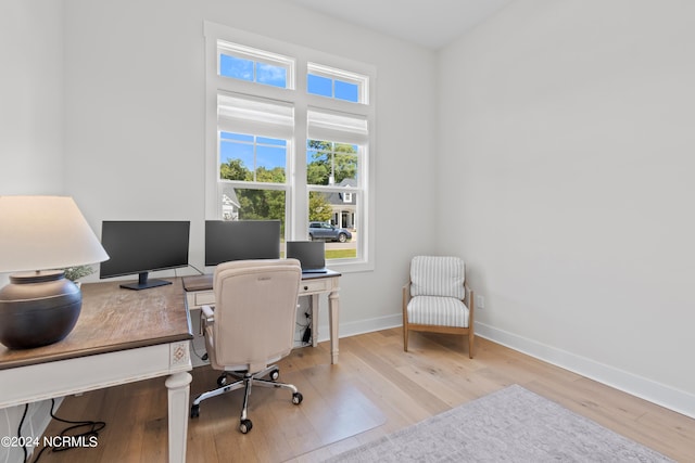 office area with light hardwood / wood-style floors