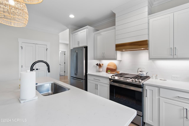 kitchen with hanging light fixtures, white cabinetry, appliances with stainless steel finishes, and crown molding