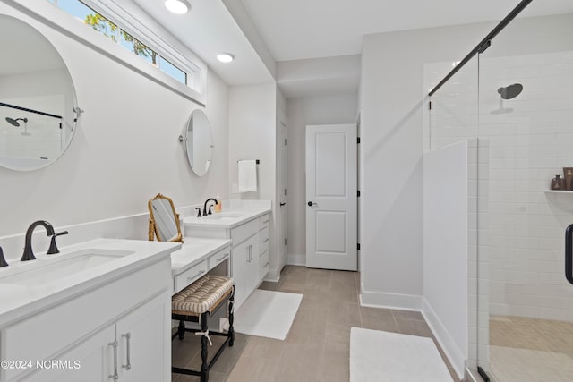 bathroom with a shower with door and vanity