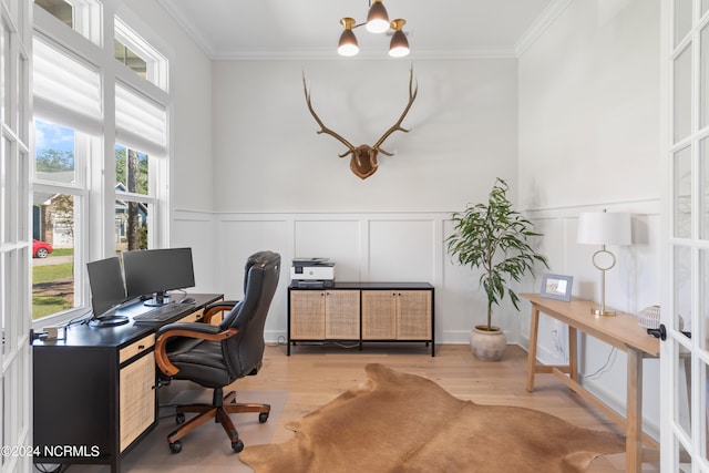 office space with crown molding, a healthy amount of sunlight, and light hardwood / wood-style flooring