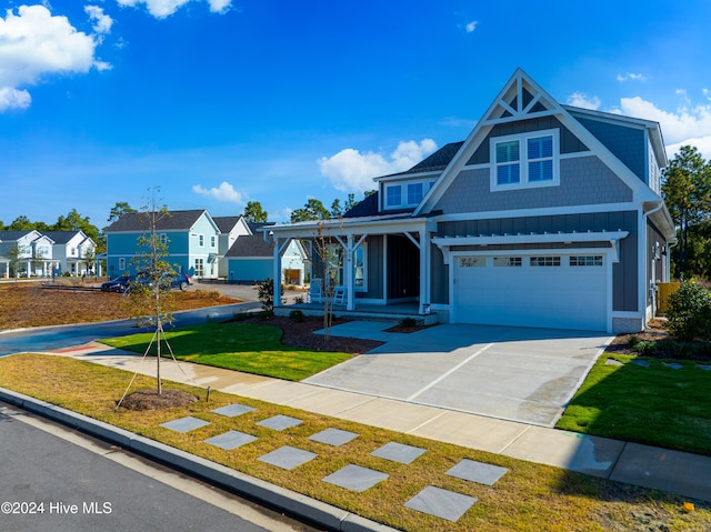 view of front of property with a garage and a front yard