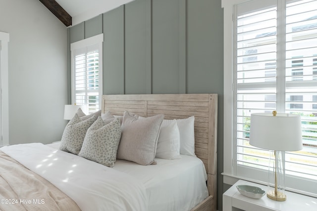 bedroom featuring vaulted ceiling with beams