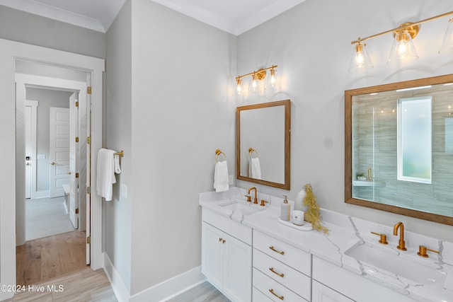 bathroom featuring an enclosed shower, vanity, wood-type flooring, and ornamental molding