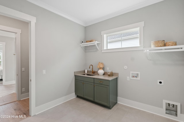 laundry area with sink, electric dryer hookup, light hardwood / wood-style flooring, crown molding, and hookup for a washing machine