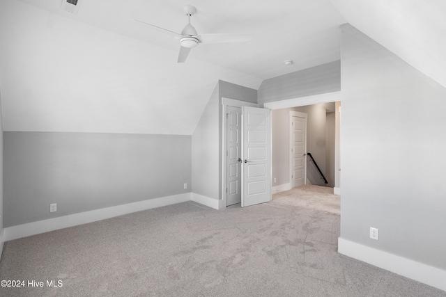 bonus room featuring ceiling fan, light carpet, and lofted ceiling