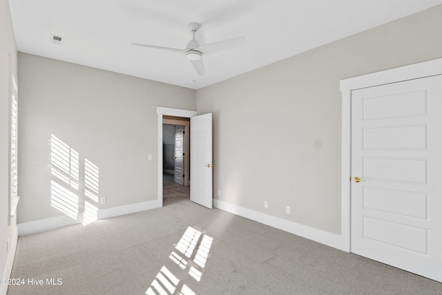 carpeted empty room with ceiling fan