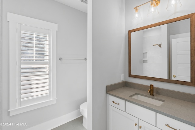 bathroom with tile patterned flooring, vanity, and toilet