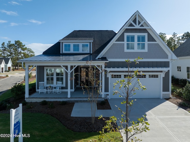 view of front of property with a garage and covered porch