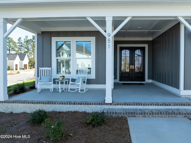 951 Trisail Ter, Wilmington, NC 28412 - property entrance with a porch, french doors, and board and batten siding