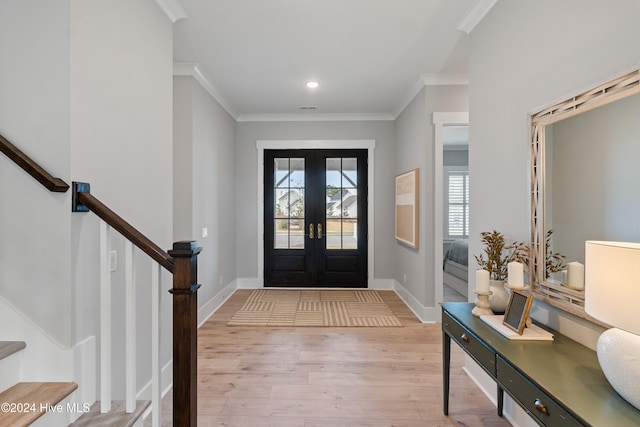 entryway featuring ornamental molding, french doors, and light hardwood / wood-style floors