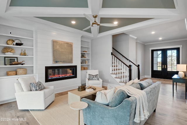 living room featuring beamed ceiling, light hardwood / wood-style flooring, french doors, and ornamental molding