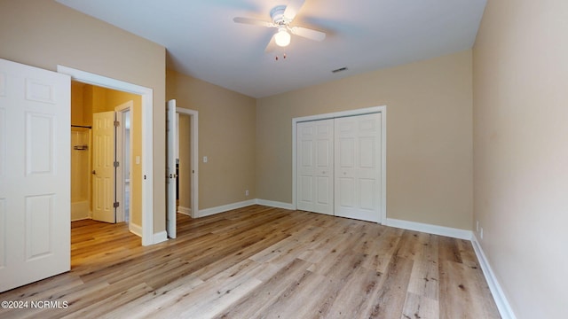 unfurnished bedroom featuring ceiling fan, a closet, and light hardwood / wood-style floors