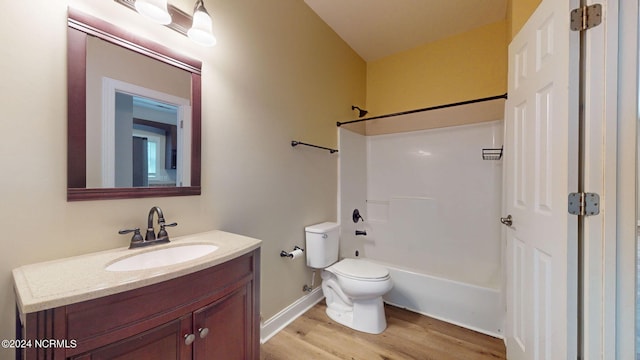 full bathroom featuring vanity, toilet, hardwood / wood-style floors, and shower / bathtub combination