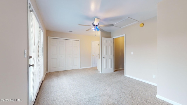 unfurnished bedroom with light colored carpet, ceiling fan, and a closet