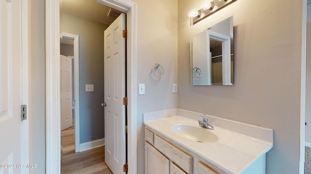 bathroom with hardwood / wood-style floors and vanity