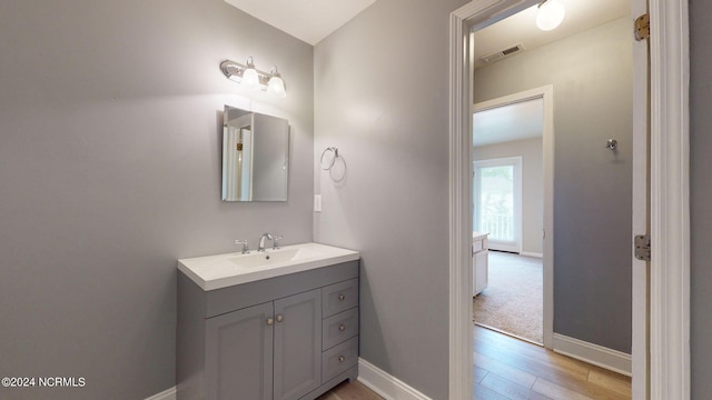 bathroom featuring vanity and hardwood / wood-style floors