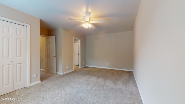 unfurnished bedroom with ceiling fan and light carpet