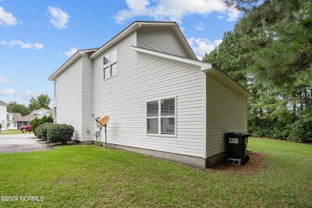 view of home's exterior with a yard