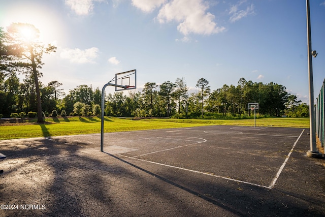 view of sport court featuring a lawn