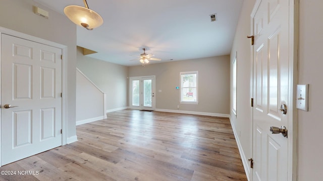 interior space with light wood-type flooring and ceiling fan