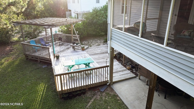 deck featuring a pergola and a lawn