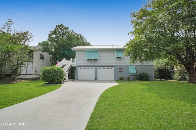 view of front of property with a garage and a front yard