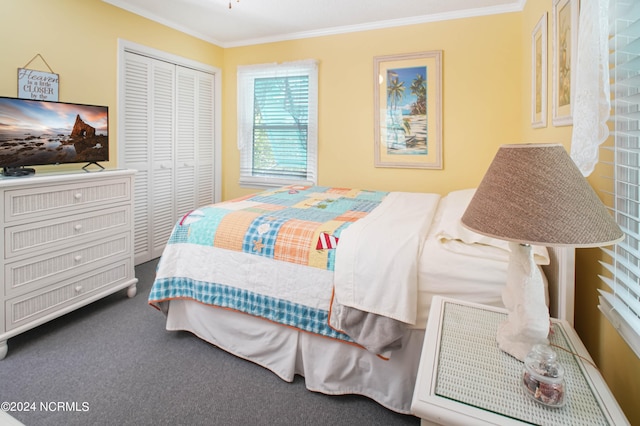 carpeted bedroom with ornamental molding and a closet