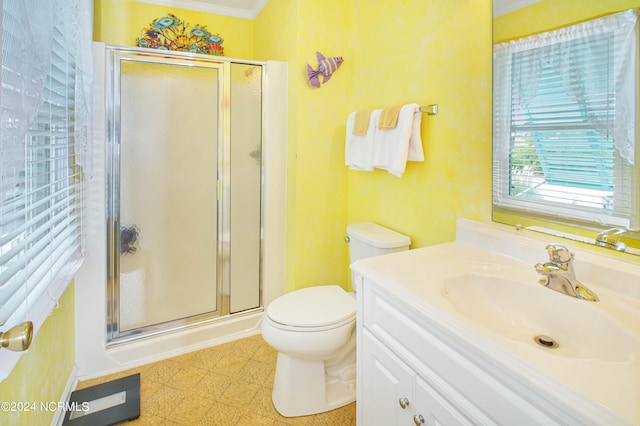 bathroom with crown molding, vanity, toilet, and a shower with shower door