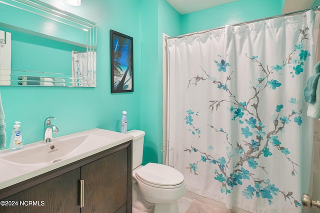 bathroom featuring tile patterned flooring, walk in shower, vanity, and toilet