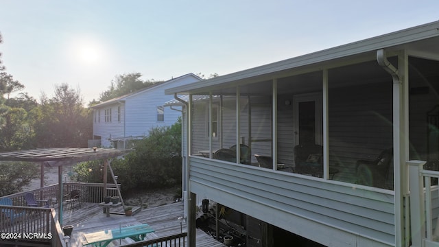 view of side of home with a deck and a pergola