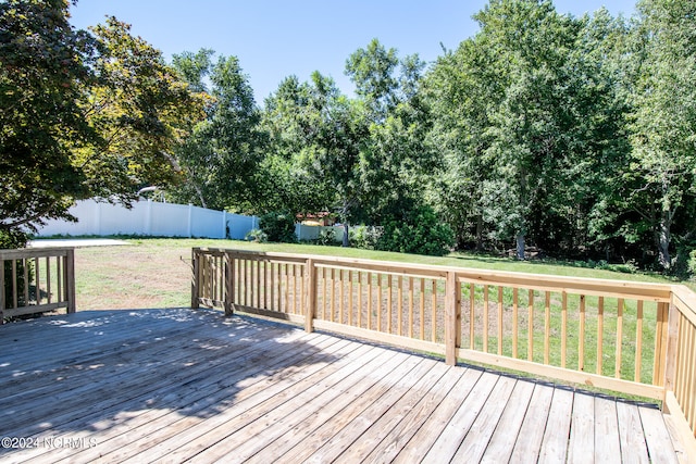 wooden terrace featuring a lawn