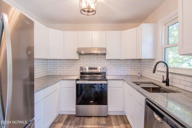 kitchen featuring stainless steel appliances, white cabinetry, and sink