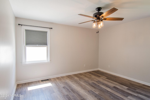 spare room featuring hardwood / wood-style floors and ceiling fan