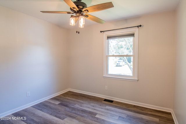 spare room with ceiling fan and wood-type flooring