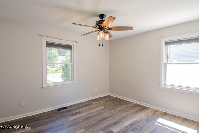 empty room with ceiling fan and hardwood / wood-style flooring