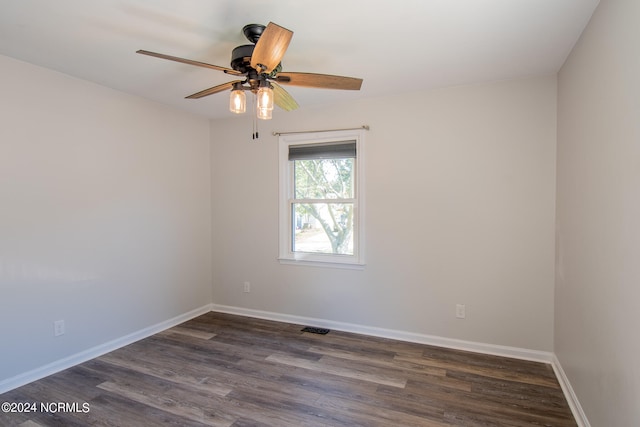 empty room with dark wood-type flooring and ceiling fan