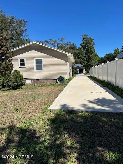 view of side of property with a yard