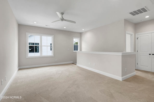 empty room with light carpet and ceiling fan