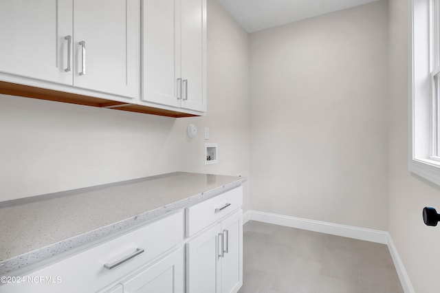 laundry room featuring cabinets and washer hookup