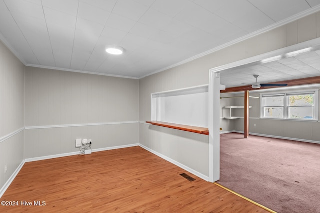 empty room featuring ornamental molding, hardwood / wood-style floors, and ceiling fan