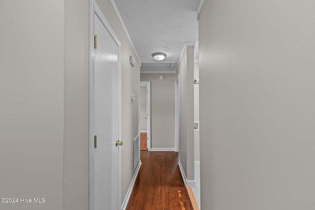 hallway featuring dark hardwood / wood-style flooring and crown molding