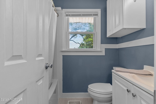 full bathroom featuring vanity, toilet, and shower / bathtub combination with curtain