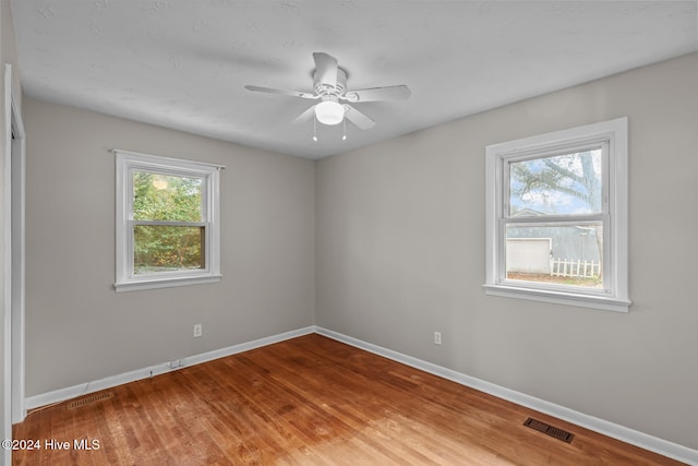 empty room featuring ceiling fan and wood-type flooring